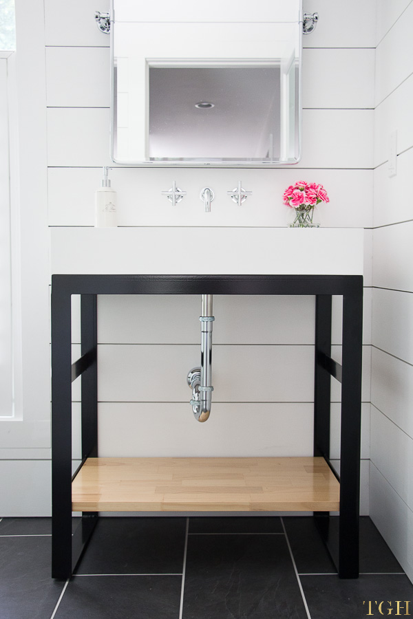 Come see this custom steel vanity in this small bathroom makeover