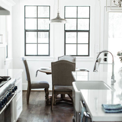 Black trim windows kitchen. Breakfast nook table round. Modern farmhouse kitchen black and white.