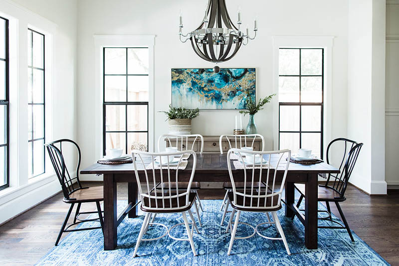 Black trim windows farmhouse. Blue rug dining room. Modern farmhouse dining chairs.