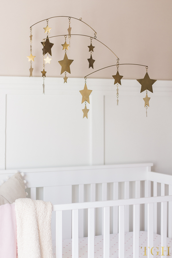 Gold Nursery Mobile Over White Crib