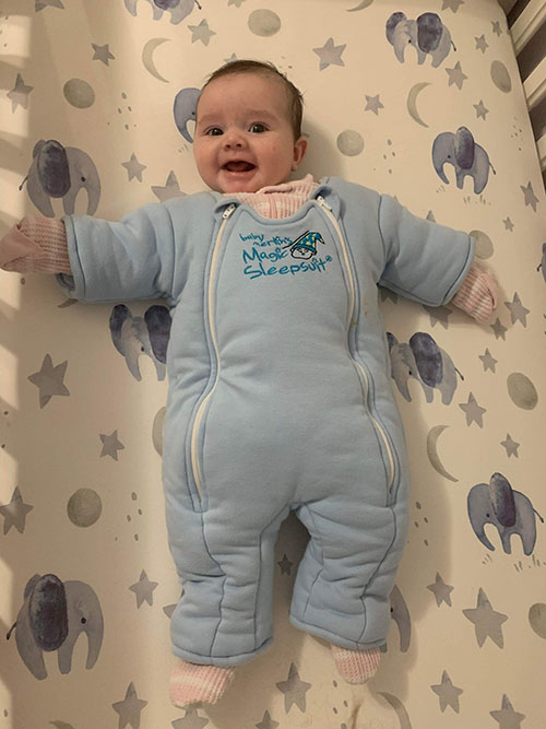 A baby wearing Merlin Sleep suit
