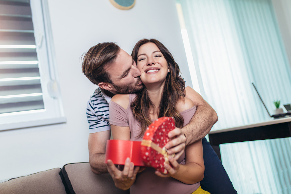 wife surprising husband with pregnancy